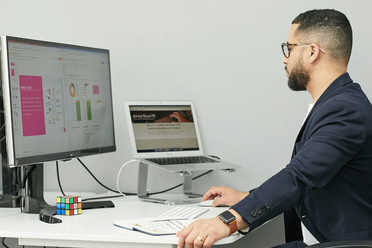 A laptop displays an analytics dashboard with graphs and statistics on user activity, engagement, and app usage metrics.